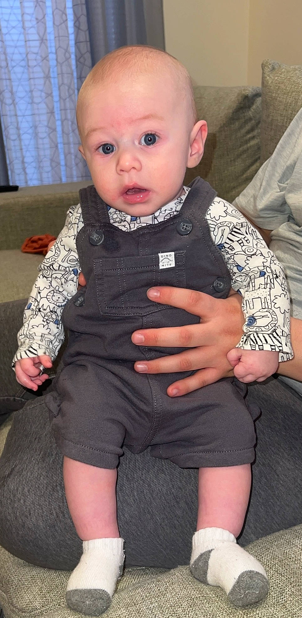 Zayden joined the competition — help win amazing prizes! baby, baby_toddler_clothing, black, cheek, child, collar, comfort, eye, eyelash, iris, joint, knee, lap, leg, person, sitting, skin, sleeve, surprise, thigh