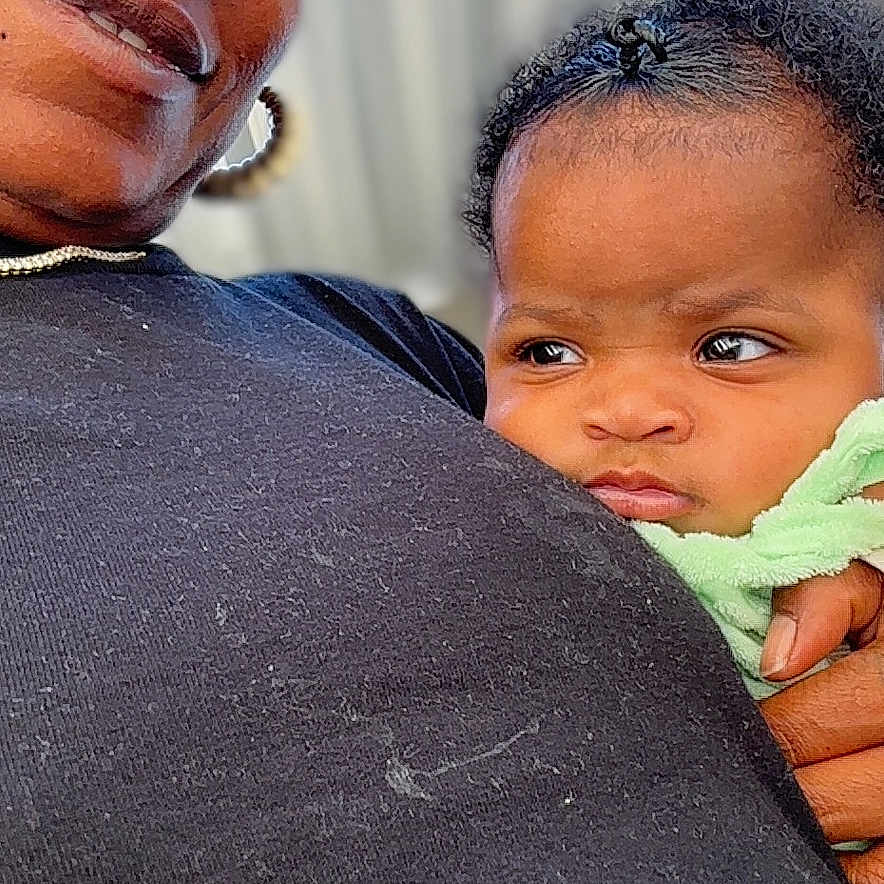 Harmonee joined the competition — help win amazing prizes! woman, baby, child, headscarf, portrait, closeup, outdoor, person, expression, holding, clothing, face, skin, hand, background, colorful, headwear, casual, adult, infant