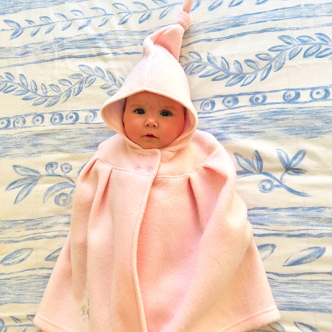 Olivia is registered to the contest to win money with this photo: baby, blanket, bonnet, cap, clothing, coat, face, fashion, hat, head, hood, hoodie, knitwear, newborn, person, photography, portrait, sweater, sweatshirt, towel