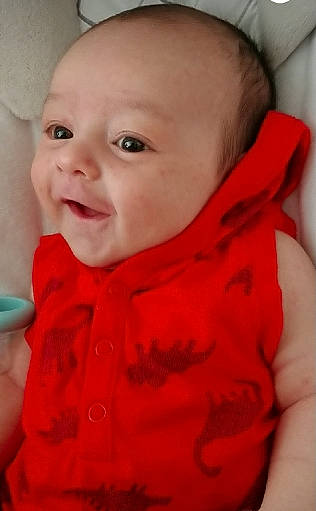 Maxwell joined the competition — help win amazing prizes! baby, cheek, child, chin, ear, eye, face, facial_expression, forehead, head, lip, mouth, neck, nose, outerwear, person, red, skin, smile, toddler