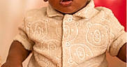Isaiah is registered to the contest to win money with this photo: baby, child, portrait, sitting, red_chair, curly_hair, smiling, wide_eyed, indoors, fashion, shirt, shoes, infant, dark_skin, red_background, photography, close_up, seated, family_photo, cute