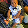 baby, child, infant, portrait, sitting, formal_clothing, bow_tie, white_shirt, shorts, adult, lap, piano, keyboard, chair, indoor, photography, looking_at_camera, serious_expression, family, cozy