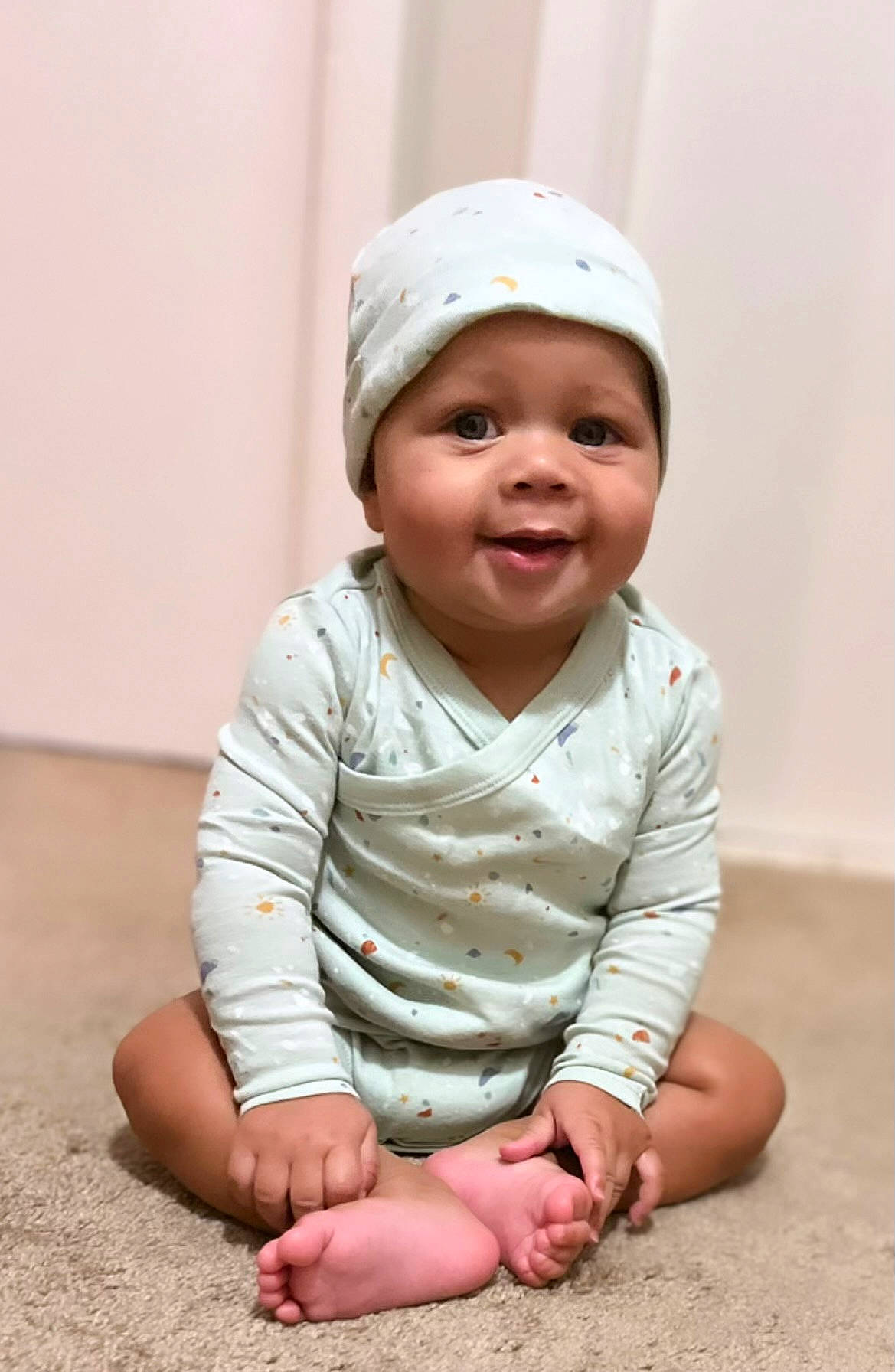 Elias is registered to the contest to win money with this photo: baby, baby_toddler_clothing, beauty, cap, cheek, child, comfort, flooring, fun, grass, happy, headwear, human_leg, joy, laugh, person, pink, portrait_photography, sitting, skin