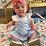 baby, child, infant, headband, pink_bow, dress, blue_dress, sitting, blanket, floral_pattern, carrot_pattern, indoor, stairs, wooden_stairs, curious_expression, footwear, shoes, cute, person, portrait