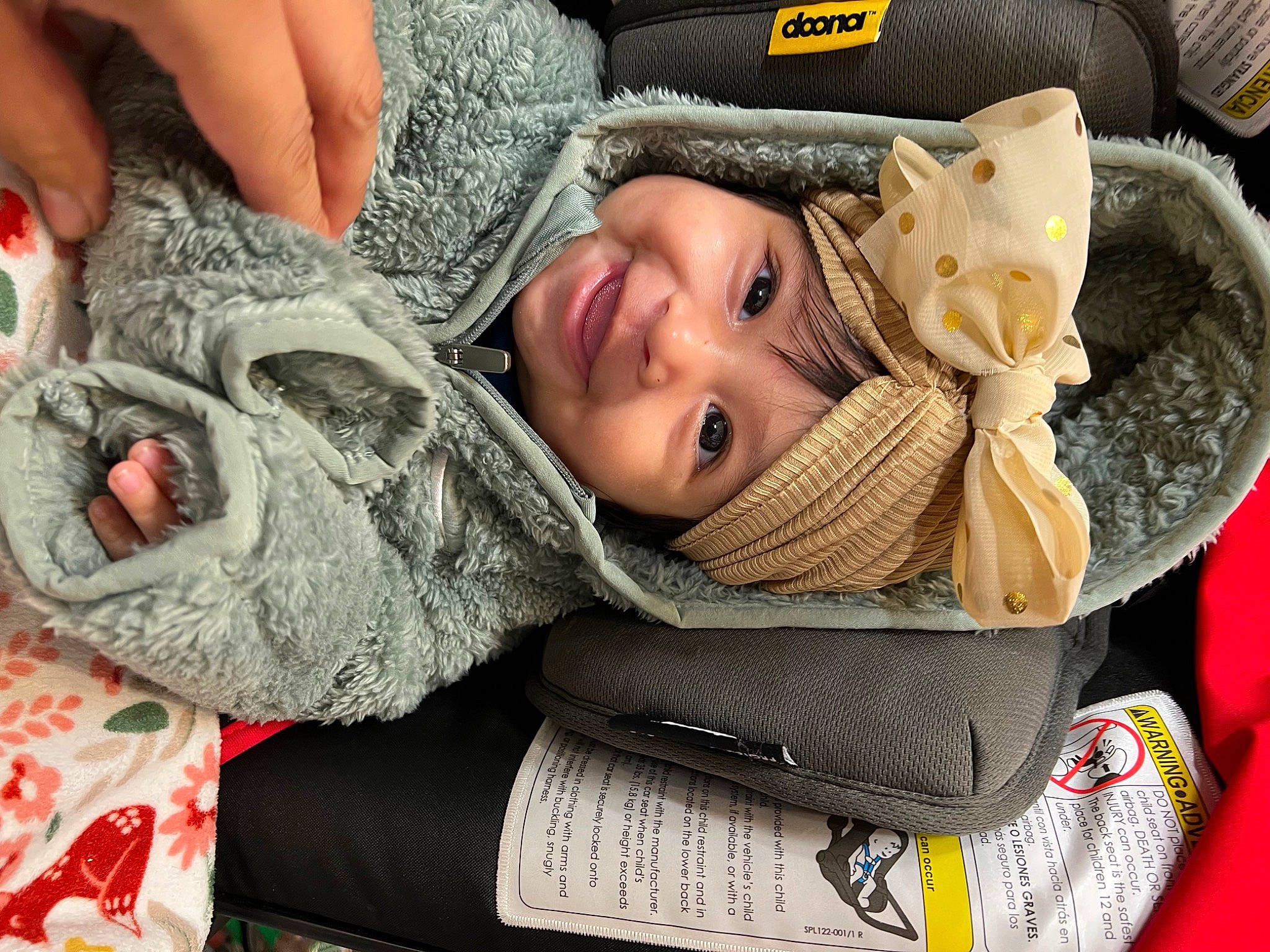 Jaylene is registered to the contest to win money with this photo: baby, baby_products, baby_toddler_clothing, comfort, cool, eye, fashion_accessory, finger, hand, happy, head, headgear, headwear, joy, linens, pattern, person, sitting, skin, smile
