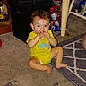 Rj joined the competition — help win amazing prizes! baby, carpet, child, cute, face, floor, furniture, hair, hand, home, indoor, living_room, person, plastic_container, playful, sitting, snack_bags, table, toddler, yellow_shirt
