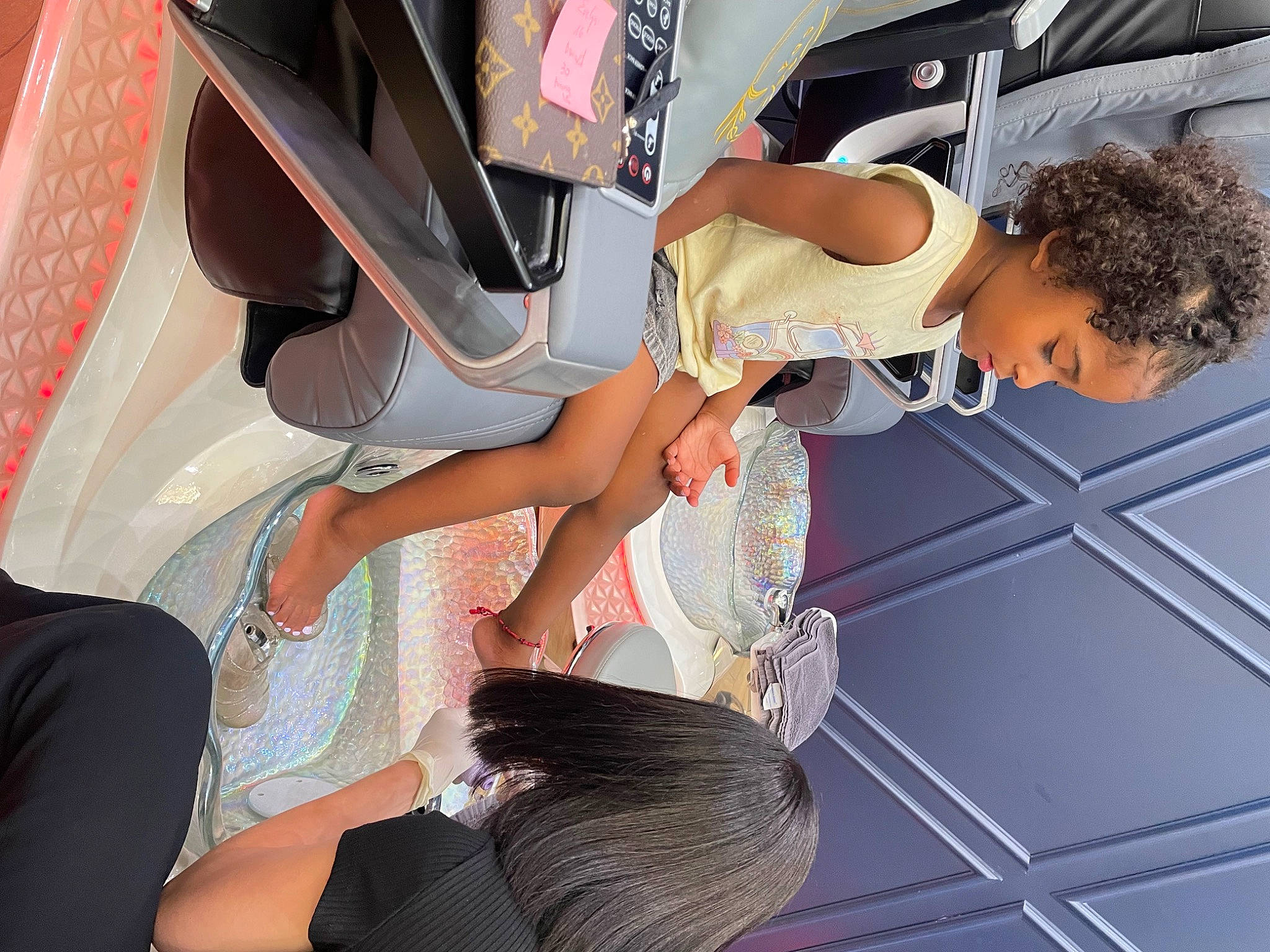 Melody is registered to the contest to win money with this photo: automotive_design, black_hair, comfort, dress, elbow, event, eyewear, fashion_design, fun, human_leg, joint, knee, leisure, luxury_vehicle, passenger, person, room, sandal, thigh