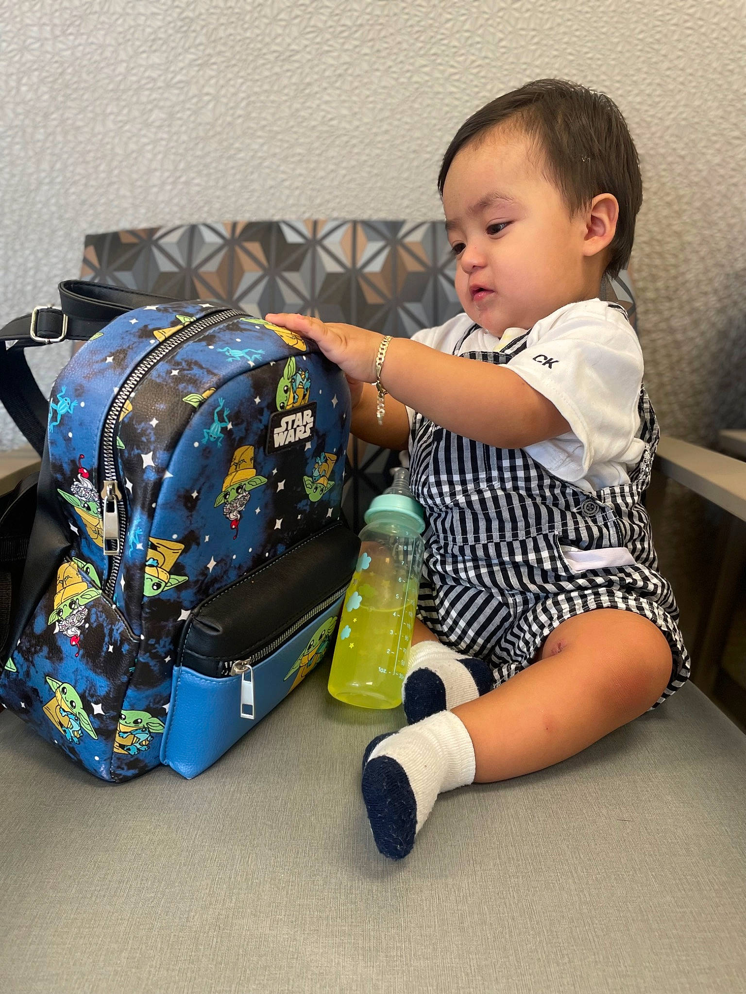 Junior joined the competition — help win amazing prizes! baby, baby_toddler_clothing, backpack, bag, cleanliness, comfort, design, flooring, foot, fun, happy, human_leg, knee, leg, luggage_and_bags, person, product, sitting, thigh, toddler
