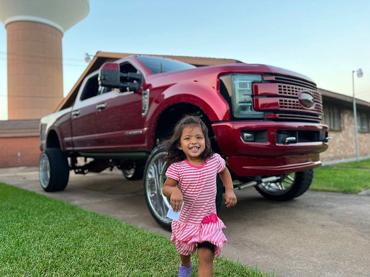 Isabella joined the competition — help win amazing prizes! alloy_wheel, automotive_design, automotive_exterior, automotive_lighting, automotive_tire, bumper, car, grille, hood, joy, motor_vehicle, person, plant, rim, sky, tire, tread, truck, vehicle, vehicle_door