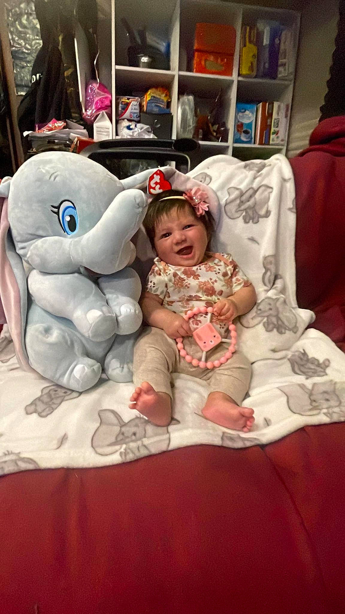 Ember is registered to the contest to win money with this photo: baby, baby_toddler_clothing, child, comfort, costume, event, fashion_accessory, fun, fur, linens, peach, person, plush, room, shelf, sitting, stuffed_toy, teddy_bear, toddler, toy
