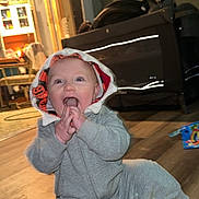 Maxton joined the competition — help win amazing prizes! baby, child, hoodie, grey_clothing, sitting, wooden_floor, indoor, toys, happy, excited, hands, mouth, pumpkin_pattern, hood, feet, barefoot, furniture, room, playpen, lighting