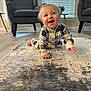 Maxton joined the competition — help win amazing prizes! baby, child, crawling, smiling, indoor, pajamas, rug, floor, armchair, window_blinds, plant, table, wood_floor, happy, person, home, living_room, furniture, cute, young