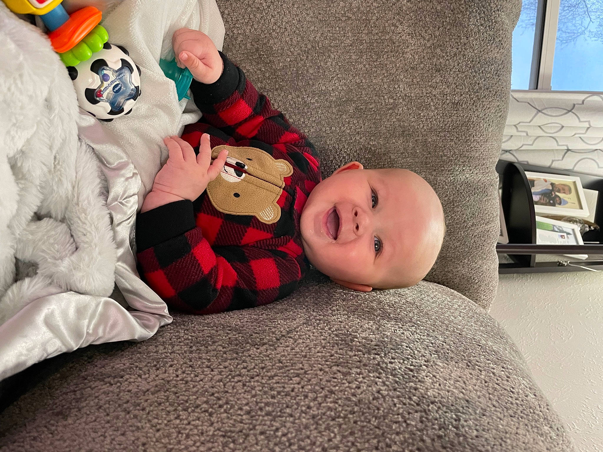Azariah is registered to the contest to win money with this photo: baby, baby_toddler_clothing, bedding, carmine, child, comfort, doll, flooring, fur, hat, lap, linens, person, plush, room, sitting, sock, stuffed_toy, toddler, toy