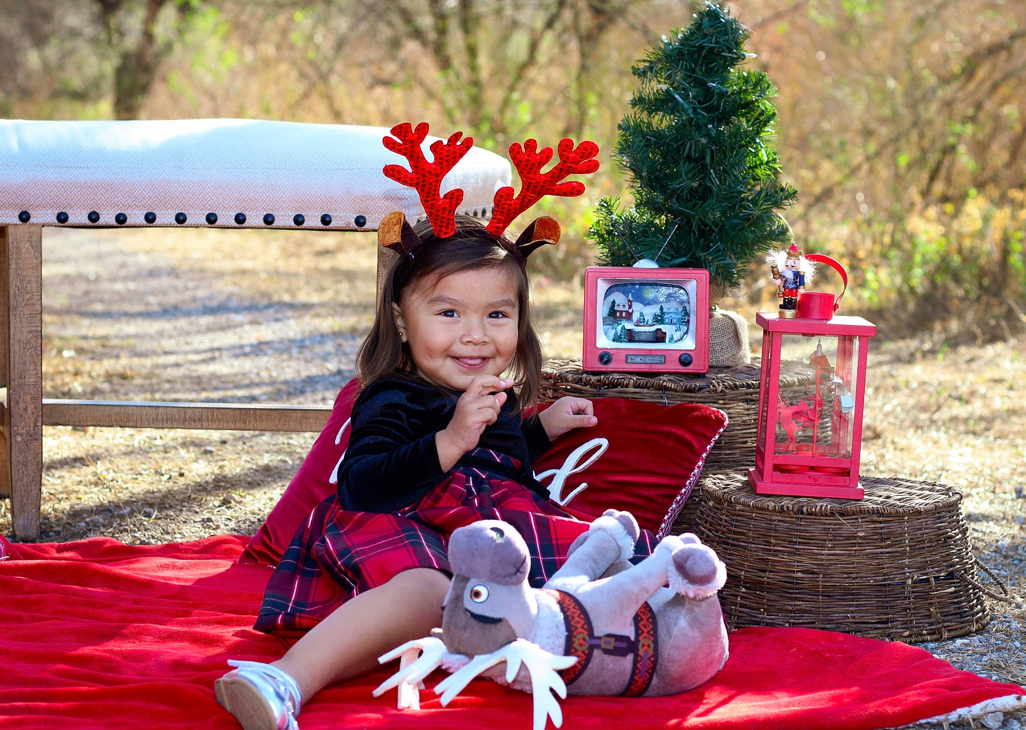 Olyvia joined the competition — help win amazing prizes! child, christmas_eve, christmas_ornament, event, facial_expression, fawn, fun, grass, happy, holiday, joy, lap, leisure, person, pink, plant, recreation, red, sitting, smile