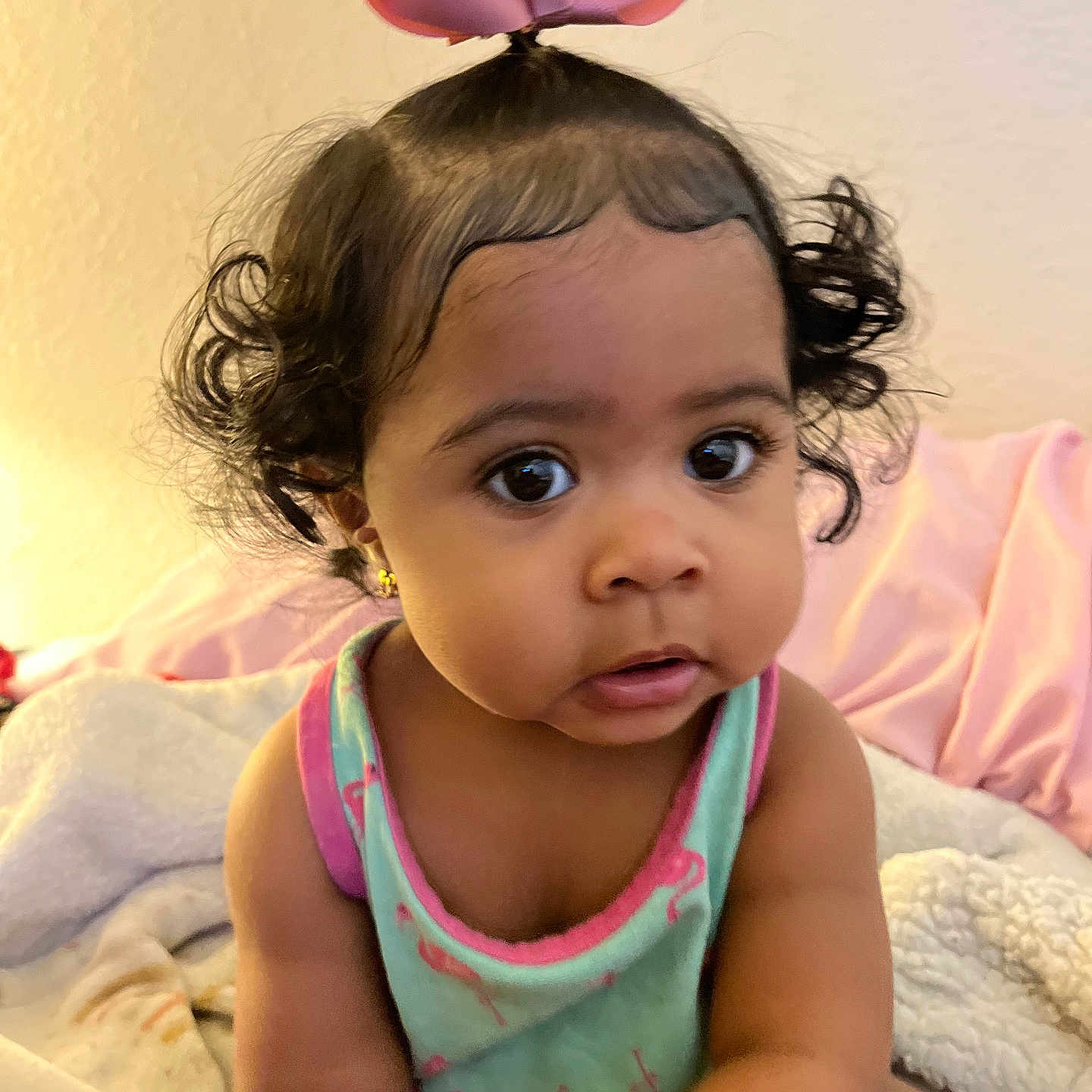 Maraya joined the competition — help win amazing prizes! baby, blanket, child, clothing, cozy, curious, curly_hair, cute, expression, face, home, indoor, person, pink_bow, portrait, sitting, skin, tank_top, toddler, young_child