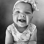 Love is registered to the contest to win money with this photo: baby, child, smiling, headband, portrait, black_and_white, happy, cute, infant, closeup, face, person, clothing, pattern, expression, young, sitting, indoors, cute_outfit, adorable