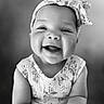 baby, child, smiling, headband, portrait, black_and_white, happy, cute, infant, closeup, face, person, clothing, pattern, expression, young, sitting, indoors, cute_outfit, adorable