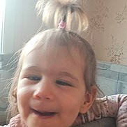 Valentyna participe au concours pour gagner de l'argent avec cette photo : baby, child, clothing, cute, expression, face, furniture, hair, hand, indoor, light, person, pink, pony_tail, portrait, skin, soft_surface, toddler, wallpaper, window