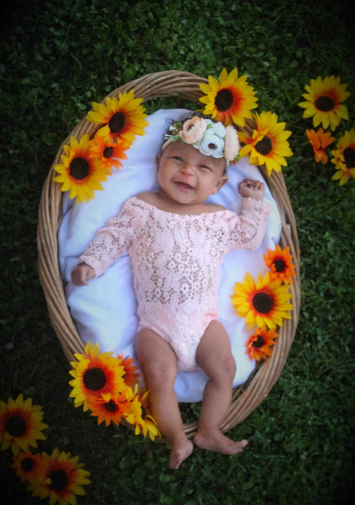 Amina joined the competition — help win amazing prizes! baby, infant, smiling, flower_crown, sunflowers, wicker_basket, grass, outdoor, pink_lace, cute, headband, nature, happy, lying_down, greenery, floral, portrait, child, one_person, baby_clothing