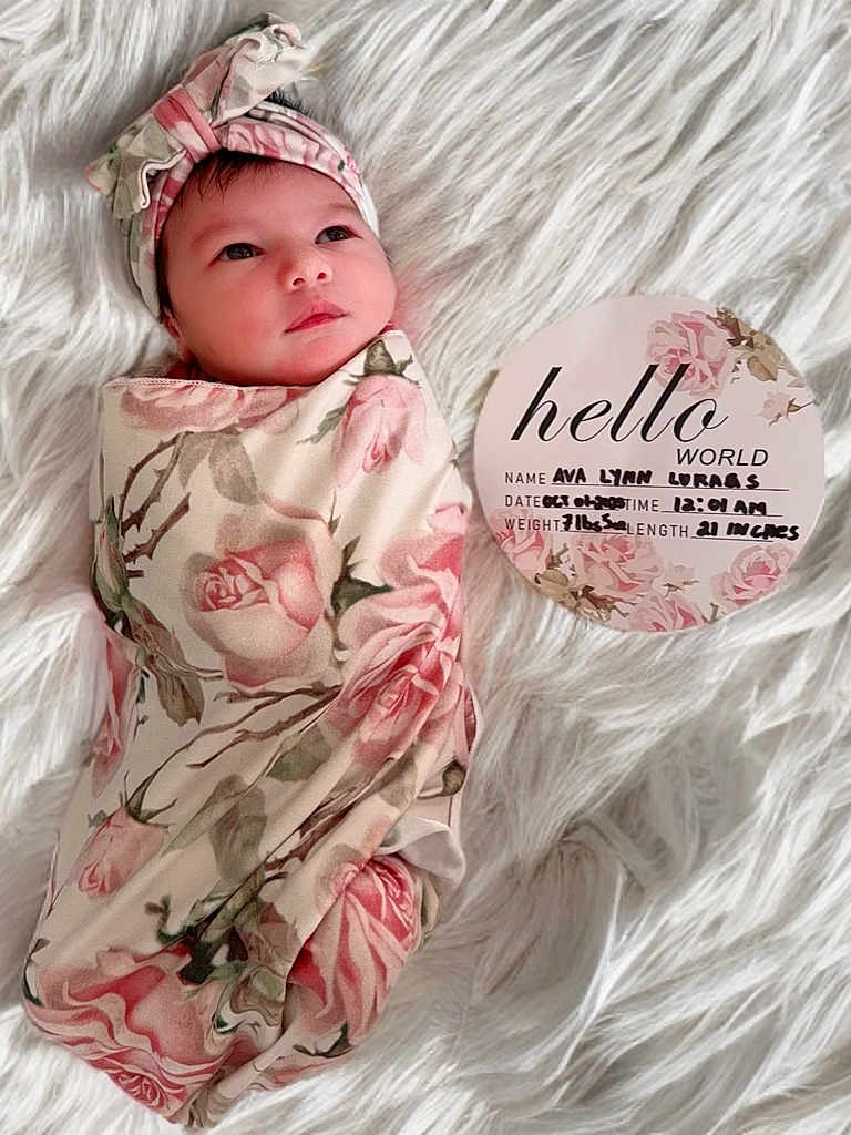 Ava is registered to the contest to win money with this photo: baby, birth_announcement, blanket, card, child, cute, face, floral_pattern, headband, indoors, infant, lying_down, newborn, peaceful, portrait, resting, soft_texture, swaddled, white_background, wrapped