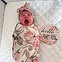 Ava joined the competition — help win amazing prizes! announcement_card, baby, birth_details, cute, floral_blanket, headband, indoor, infant, lying_down, newborn, pink, portrait, quilted_surface, resting, sleepy, soft_lighting, swaddled, white, wrapped, yawning