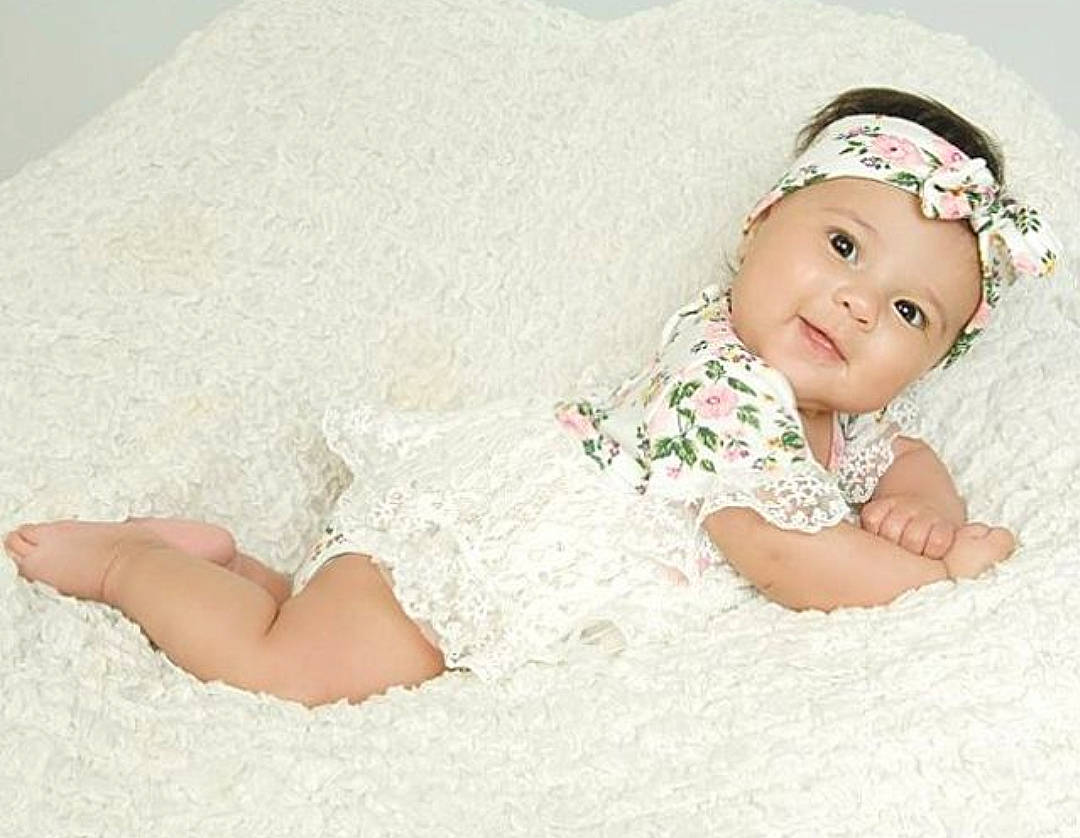 Eliyana is registered to the contest to win money with this photo: baby, baby_products, baby_sleeping, baby_toddler_clothing, barefoot, child, dress, fashion_accessory, hair_accessory, headgear, headpiece, headwear, person, photography, pink, product, skin, toddler