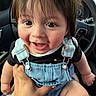 baby, child, smiling, denim_overalls, black_shirt, car_interior, steering_wheel, hand, person, cute, happy, closeup, infant, baby_face, seat, window, skin, hair, eyes, tooth