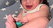 Aarón joined the competition — help win amazing prizes! baby, child, smiling, happy, foot, hand, hair, face, cushion, seat, stars, clothing, indoor, skin, infant, cute, portrait, baby_toy, playful, relaxed