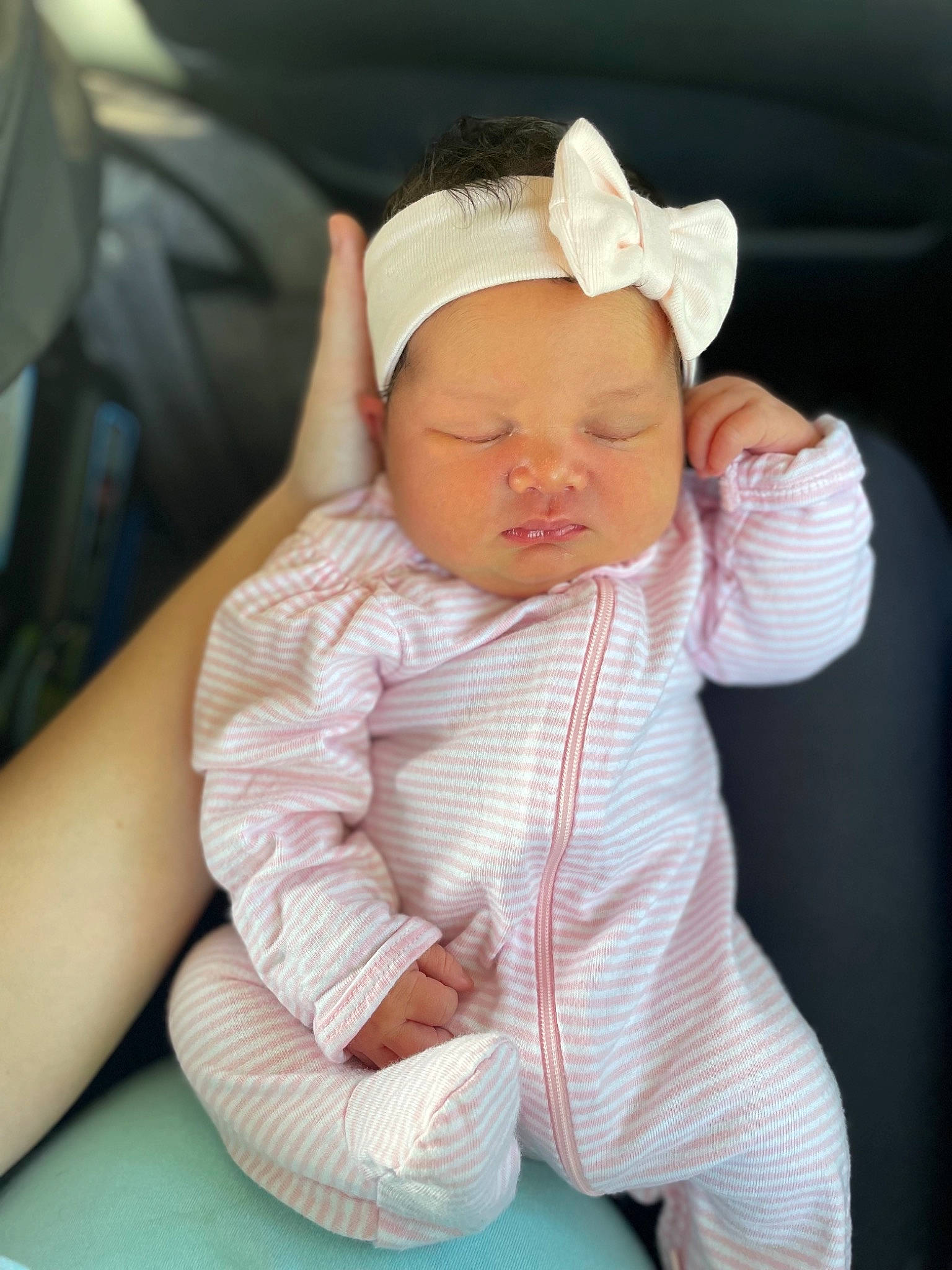 Jersey is registered to the contest to win money with this photo: baby, baby_products, baby_sleeping, baby_toddler_clothing, cap, car_seat, cheek, child, comfort, fashion_accessory, finger, gesture, human_body, linens, lip, person, sitting, skin, sleeve, thumb