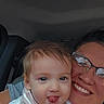 adult, affection, baby, car_interior, casual, child, closeup, clothing, face, glasses, hair, happy, joy, person, portrait, seat, smile, togetherness, tongue_out, window