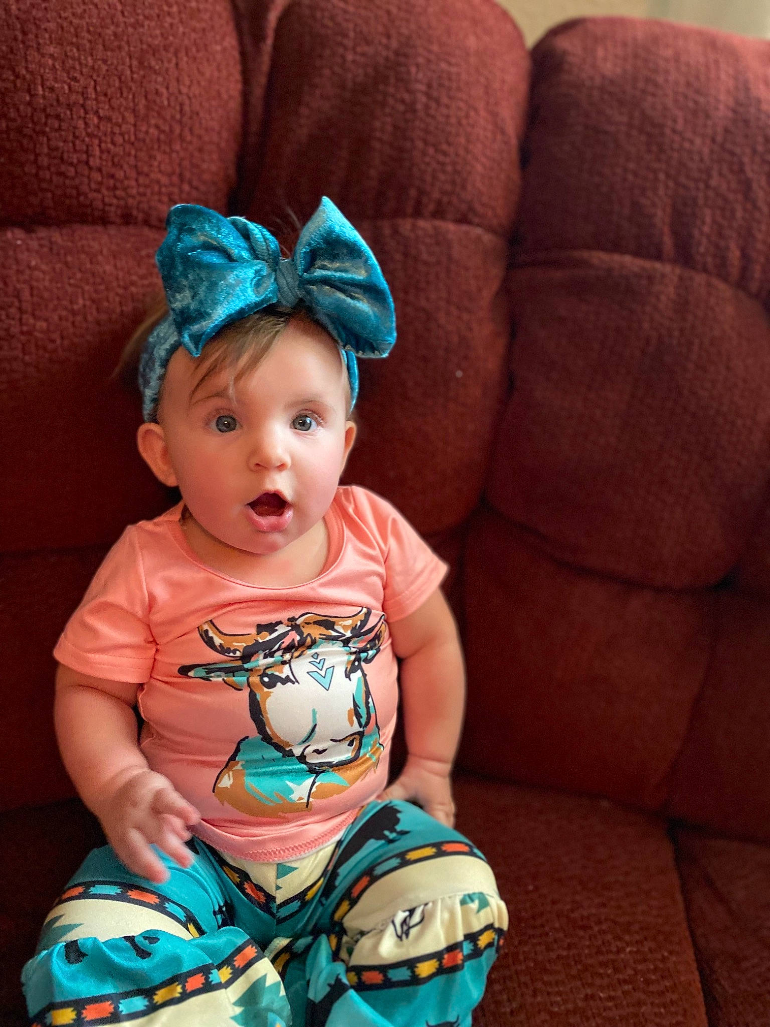 Kodie joined the competition — help win amazing prizes! baby, baby_toddler_clothing, cap, child, clothing, comfort, cool, costume_hat, couch, happy, head, headband, headpiece, jewellery, pattern, person, sitting, sleeve, surprise, textile