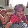 baby, child, adult, family, selfie, smartphone, indoors, living_room, couch, blanket, window, curtains, sunlight, red_shirt, glasses, smiling, crawling, sitting, portrait, home