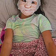 Cattaleya joined the competition — help win amazing prizes! child, girl, face_mask, facial_treatment, smiling, lying_down, bed, pillow, blanket, tablet, minecraft, video_game, bedroom, portrait, indoors, casual_clothing, dark_hair, relaxed, playful, home