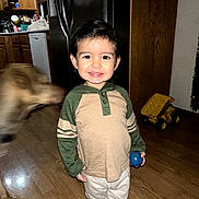 Elias joined the competition — help win amazing prizes! ball, barefoot, cabinets, child, clothing, dog, door, family_photo, home, indoors, kitchen, pet, portrait, refrigerator, smiling, standing, striped_sleeves, toddler, toy_truck, wood_floor