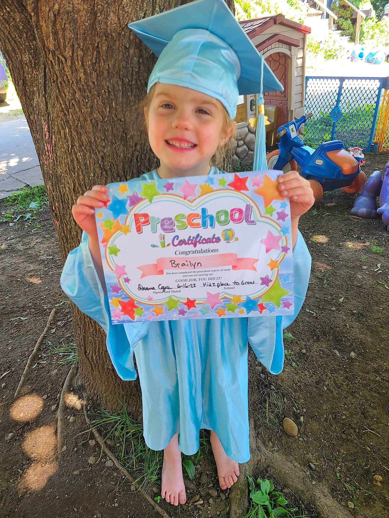 Brailyn is registered to the contest to win money with this photo: blue, child, costume, electric_blue, event, fun, grass, happy, headwear, joy, leaf, leisure, mortarboard, person, plant, recreation, sleeve, smile, soil, t_shirt