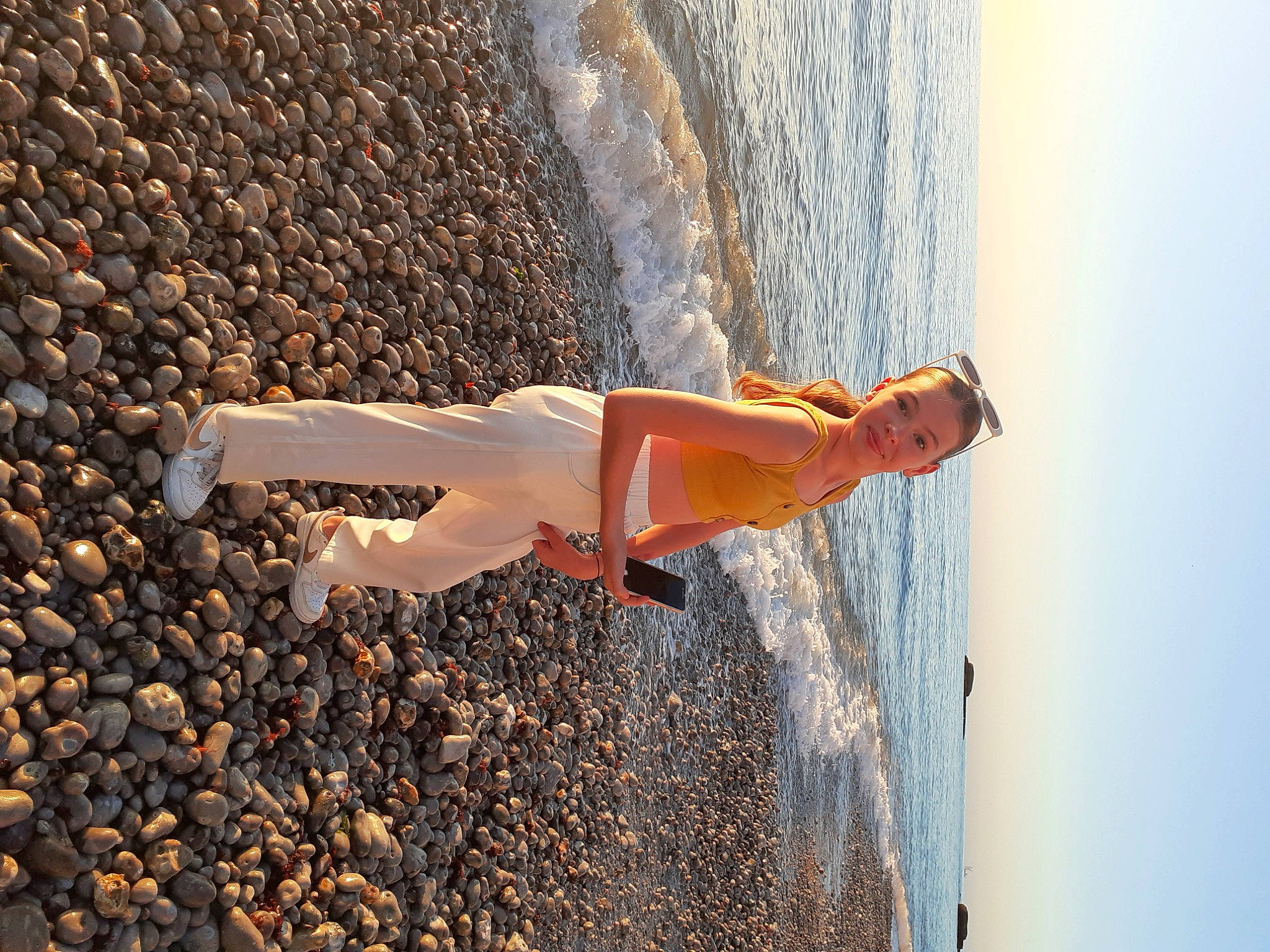 Camille participe au concours pour gagner de l'argent avec cette photo : beach, body_of_water, dress, fun, happy, human_body, joy, landscape, leg, leisure, ocean, people_in_nature, person, rock, sand, shadow, sky, soil, water, wave