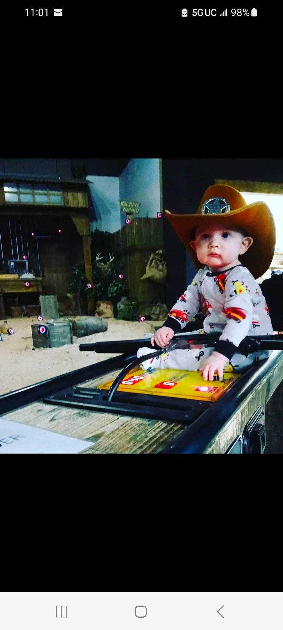 Joseph is registered to the contest to win money with this photo: baby, cap, child, costume_hat, fashion_accessory, fedora, fun, gadget, glass, hat, headwear, person, play, recreation, room, sitting, sun_hat, toddler, travel