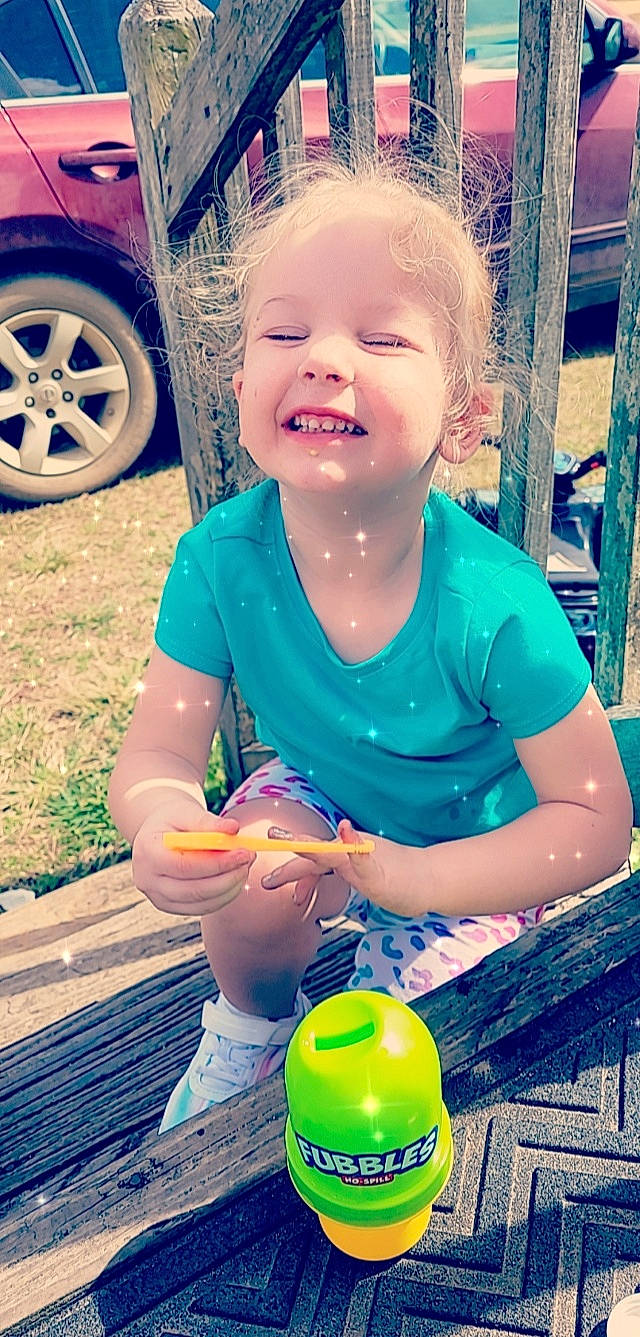 Brinley joined the competition — help win amazing prizes! automotive_tire, baby_toddler_clothing, blue, car, clothing, cool, fender, grass, green, happy, joy, light, person, photograph, product, smile, summer, t_shirt, tire, toddler