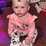 Lyla joined the competition — help win amazing prizes! baby, child, infant, pink_clothing, headband, cow_print, sitting, indoor, quilted_bedspread, dresser, footwear, earrings, portrait, cute, young_child, soft_lighting, purple_flare, red_flare, expressionless, home_interior