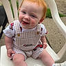 Lyla is registered to the contest to win money with this photo: toddler, child, red_hair, white_chair, outdoor, grass, concrete, overalls, white_shoes, playful, tongue_out, cute, smiling, sitting, young_child, casual_clothing, daylight, fun, happy, person