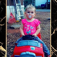Alissa joined the competition — help win amazing prizes! child, toddler, baby, portrait, outdoor, backyard, toy_car, red_car, sitting, pacifier, pink_shirt, blue_pants, blonde_hair, smiling, playtime, ladder, shed, driveway, framed_photo, marble_background