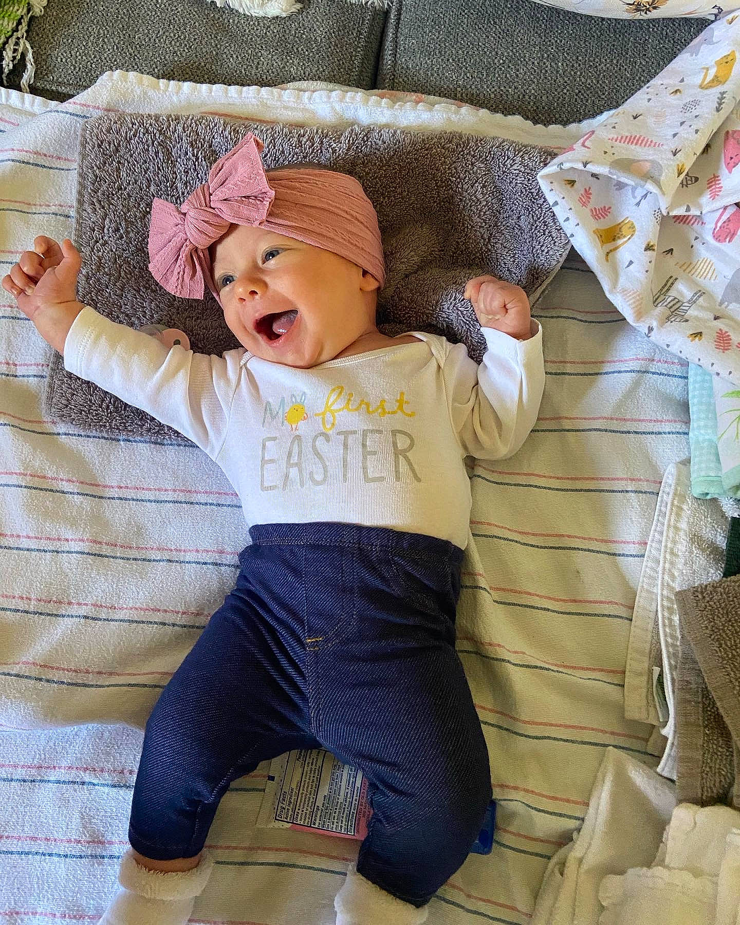Layla is registered to the contest to win money with this photo: baby, baby_toddler_clothing, cap, comfort, couch, hat, headgear, headwear, human_leg, linens, pattern, person, pink, sleeve, sportswear, sun_hat, sunglasses, t_shirt, textile, thigh