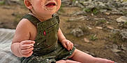 Conner joined the competition — help win amazing prizes! toddler, child, smiling, outdoor, nature, blanket, creek, rocks, greenery, happy, messy_face, overalls, barefoot, grass, daylight, portrait, sitting, baby, playful, cute