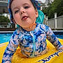 toddler, child, pool, water, float, swimsuit, hat, summer, outdoor, playful, tongue_out, blue, yellow, face, person, fun, sun_protection, daylight, recreation, backyard