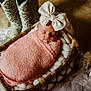 Piper is registered to the contest to win money with this photo: baby, sleeping, bow, headband, pink_wrap, wicker_basket, cushion, cowboy_boots, turquoise_boots, fabric, soft_texture, cozy, indoor, portrait, newborn, infant, rest, cute, child, peaceful