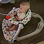 baby, walker, toy, carpet, blanket, infant, indoor, child, clothing, foot, seat, furniture, person, playtime, colorful, patterned, comfort, young_child, home, baby_gear