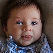 Paolo a rejoint le concours — aidez-le/la à gagner de superbes lots ! baby, infant, blue_eyes, tongue, striped_shirt, buttoned_shirt, closeup, face, cute, portrait, child, young, soft_background, lying_down, adorable, skin, head, expression, clothing, button