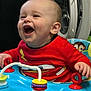 baby, child, laughing, red_shirt, cartoon, toy, activity_center, rings, indoor, washing_machine, happy, play, infant, smile, hand, face, clothing, seat, colorful, fun