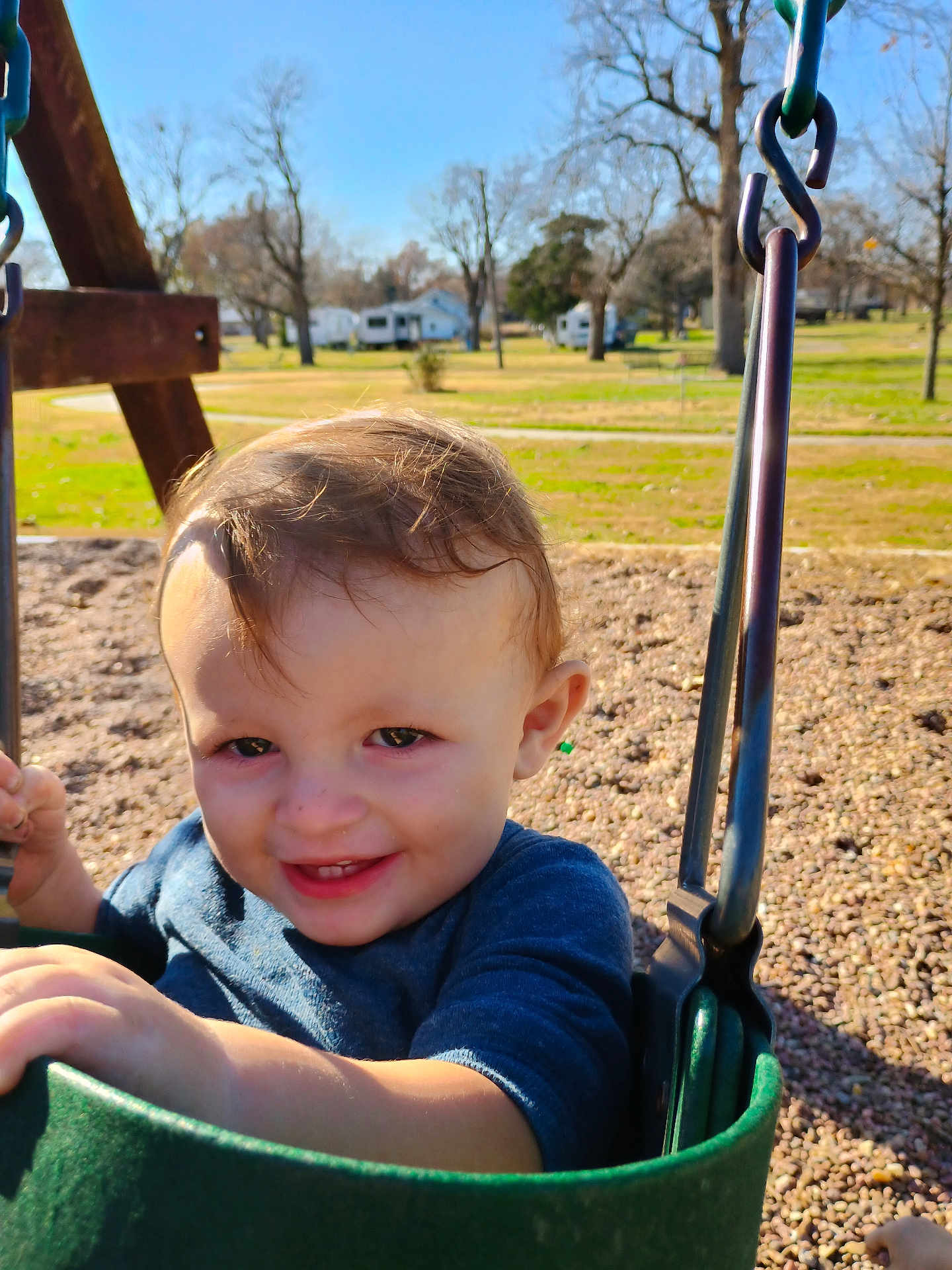 Lane joined the competition — help win amazing prizes! child, toddler, swing, playground, smile, happy, outdoor, park, green, clothing, daylight, trees, grass, blue_sky, person, seat, play, young_child, fun, nature