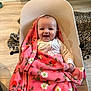 Zaria joined the competition — help win amazing prizes! baby, blanket, pink, smiling, baby_seat, indoor, floor, wooden_floor, cozy, happy, child, face, infant, clothing, patterned_blanket, floral, home, comfort, sitting, cute
